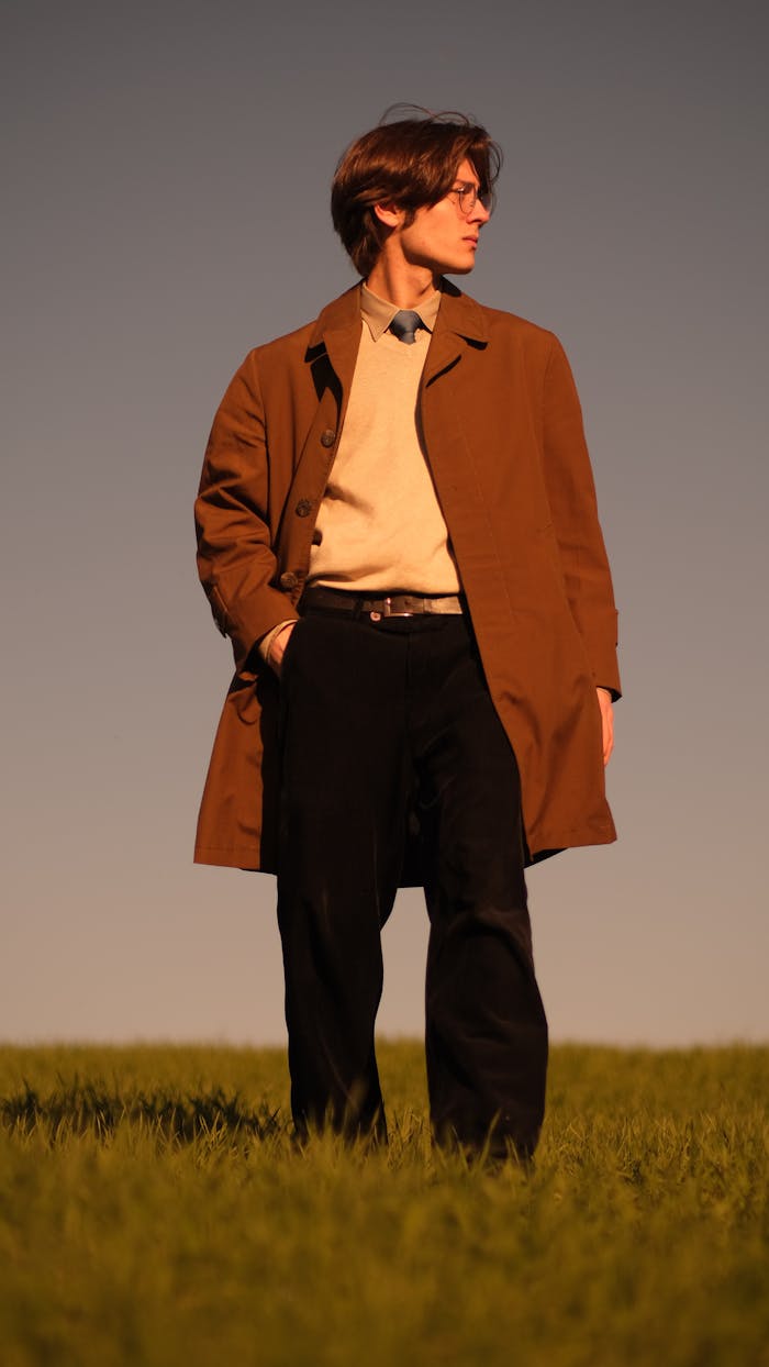 Young Man Posing in a Fashionable Outfit on a Grassland